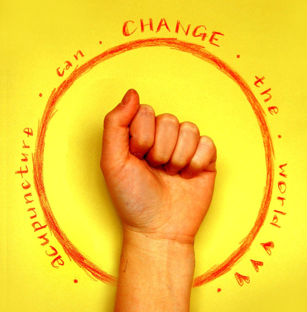 Acupuncture can change the world in red on a yellow background with Christina Chan's fist in the foreground