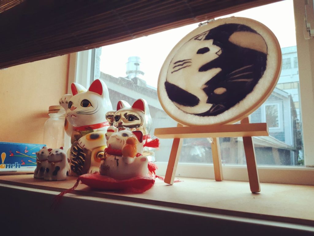 Ceramic manekineko on the kitchen windowsill.