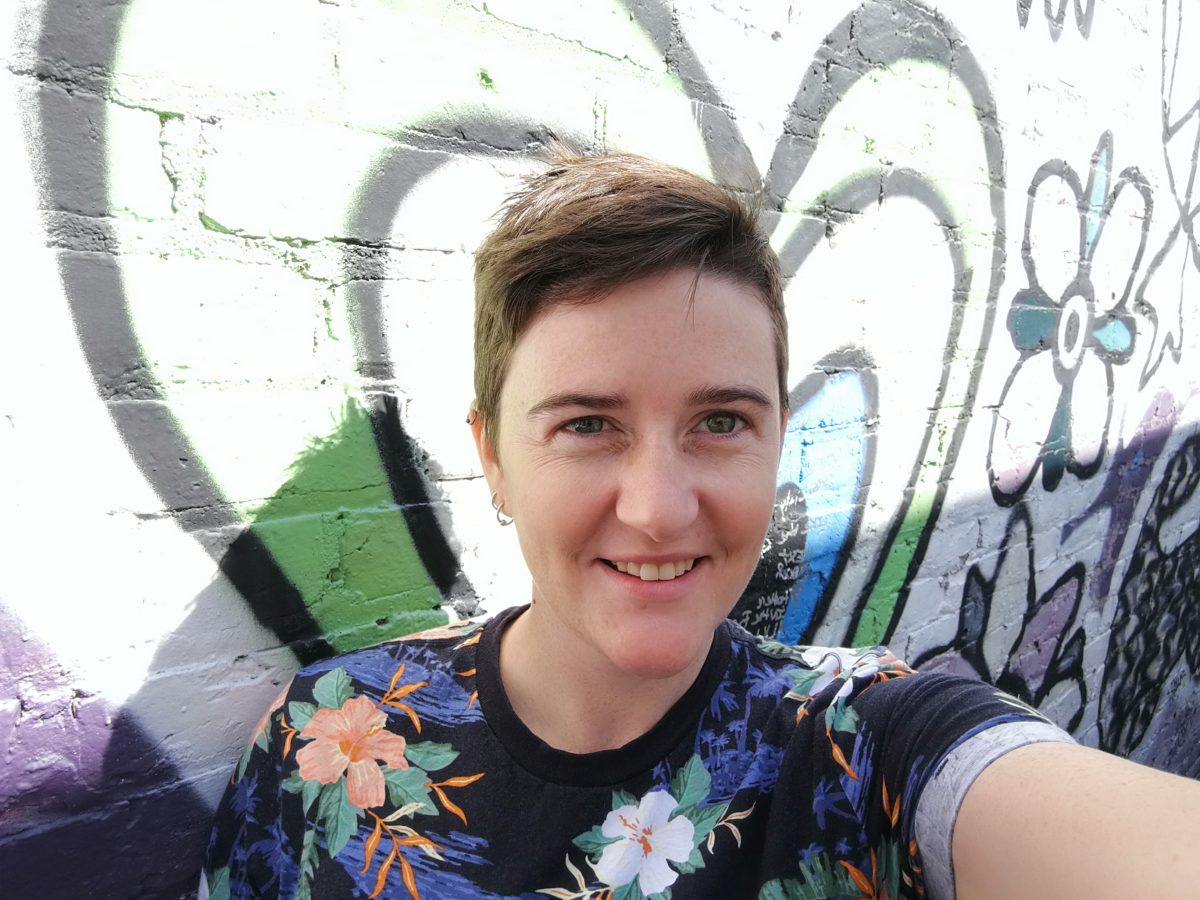 Katie has taken a selfie in front of our mural